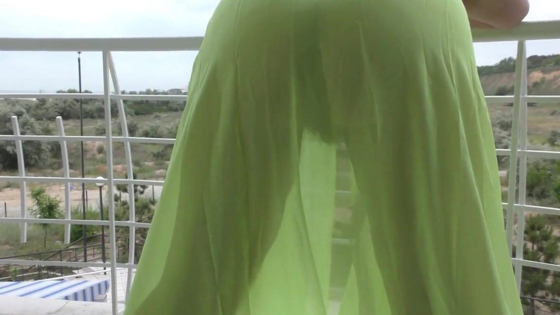 Hairy aged displaying on balcony Hairy older in semi-transparent suit on balcony